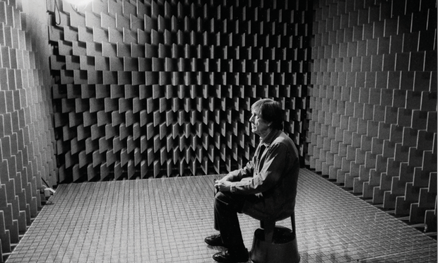 John Cage sitting in an anechoic chamber in 1951