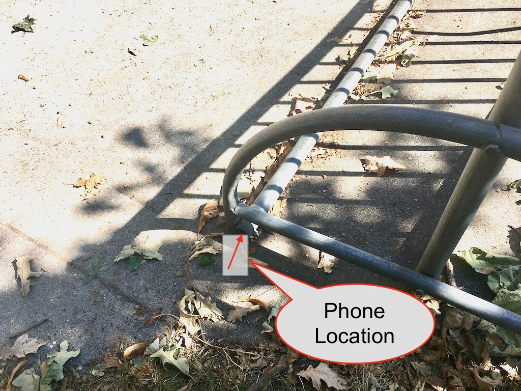 Close shot of the bike rack pipe, as well as the placement of the phone